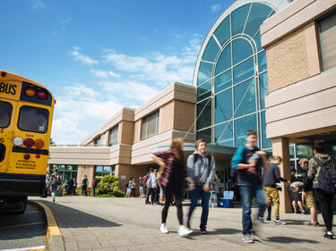 students walking in front of school