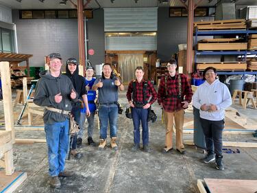 7 male students part of the skills competition pose for photo