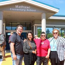 Board chair, District Vice Principal, President of FV Metis association and Assistant Superintendent pose together in front of school