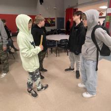 4 middle school male students standing together